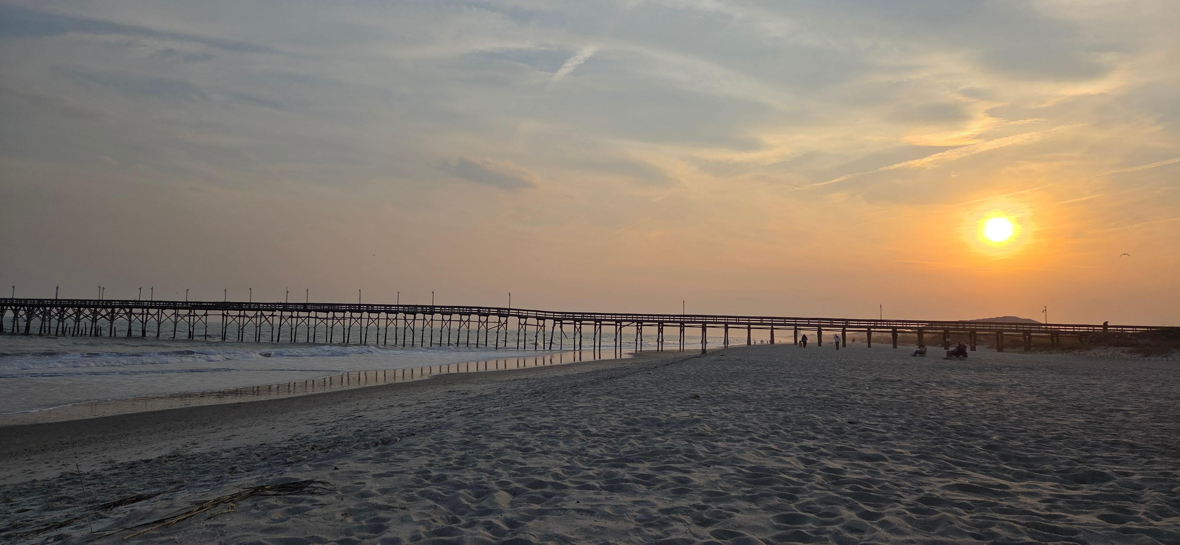 Pier and sunset on the beach in front of Pierfect.