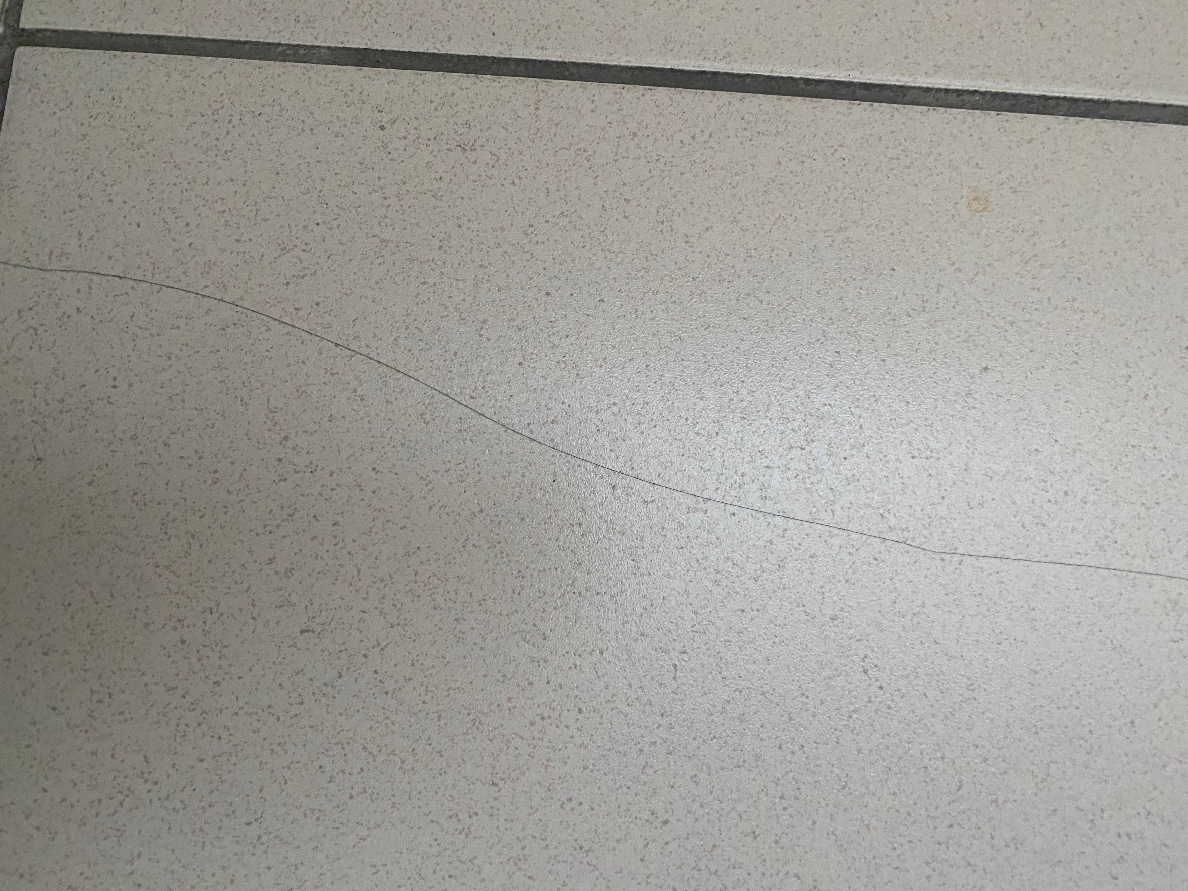 Multi cracks over floor tiles in bathroom 