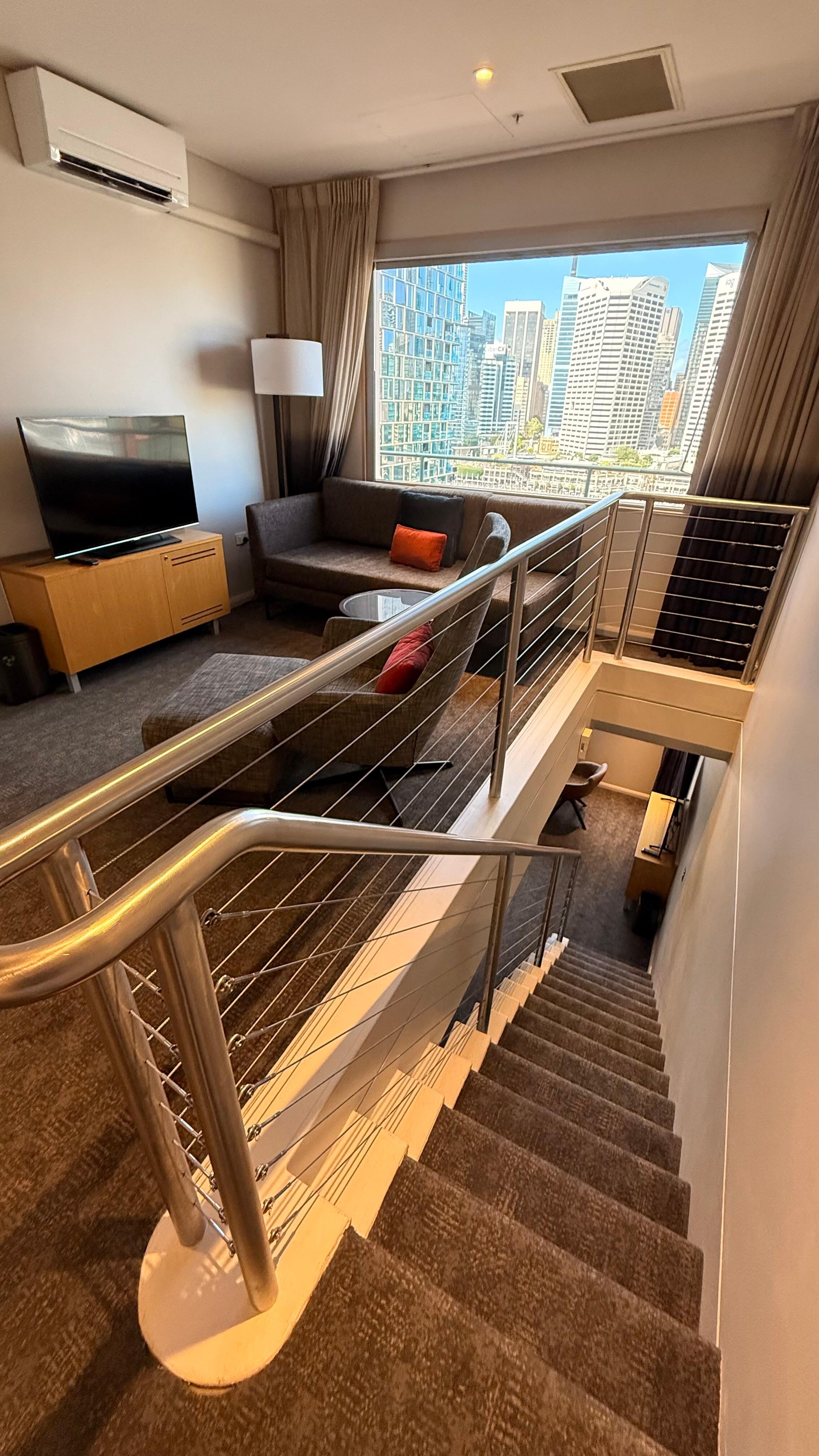 Landing with lounge , Tv , looking down the stairs 