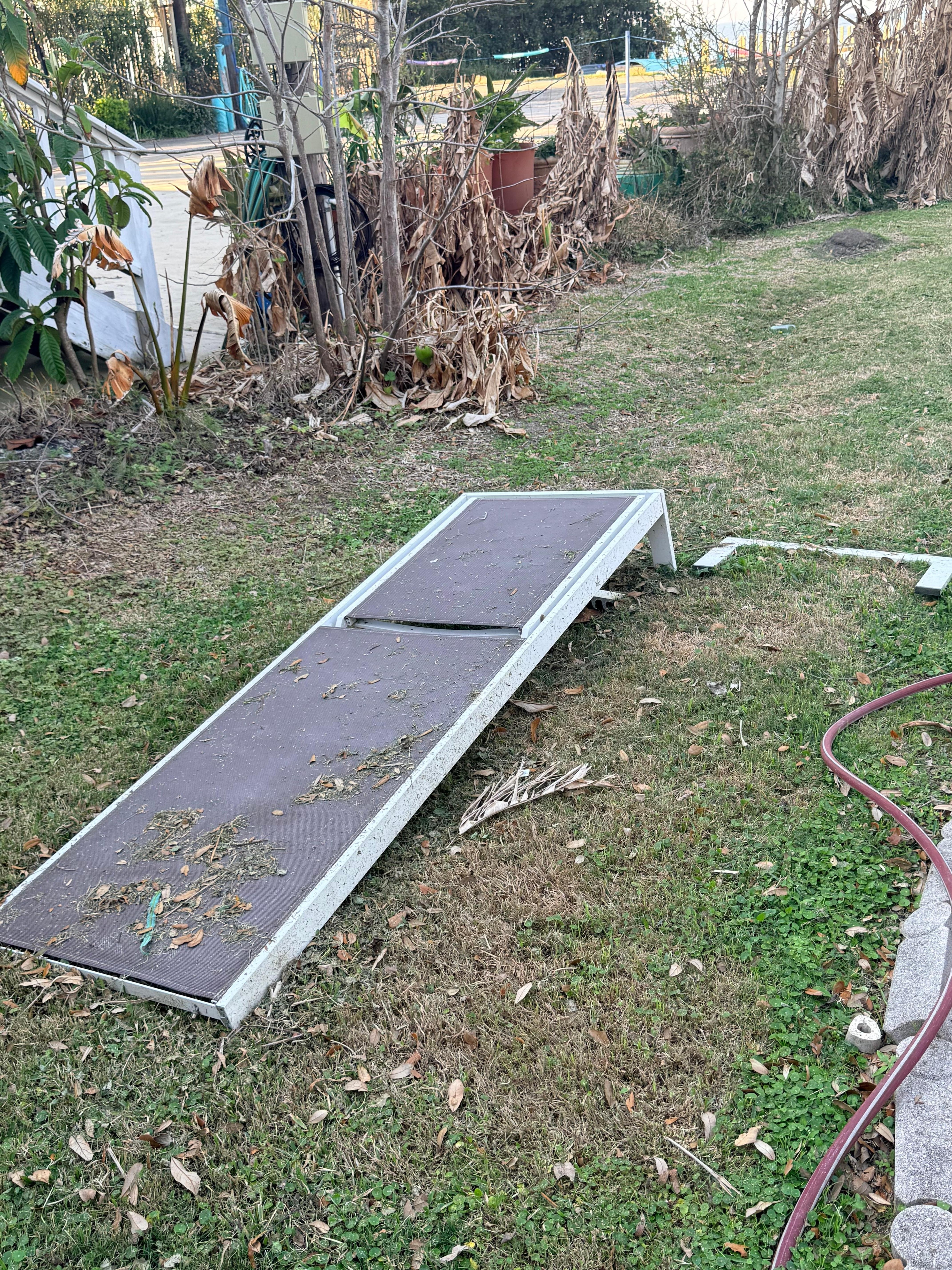 Broken furniture was left to die in the yard with shards of plastic lying next to it like it hasn’t been used anytime recently. 