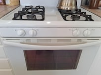 The left burner was after it got turned OFF. It was in the upright position leaking gas out.