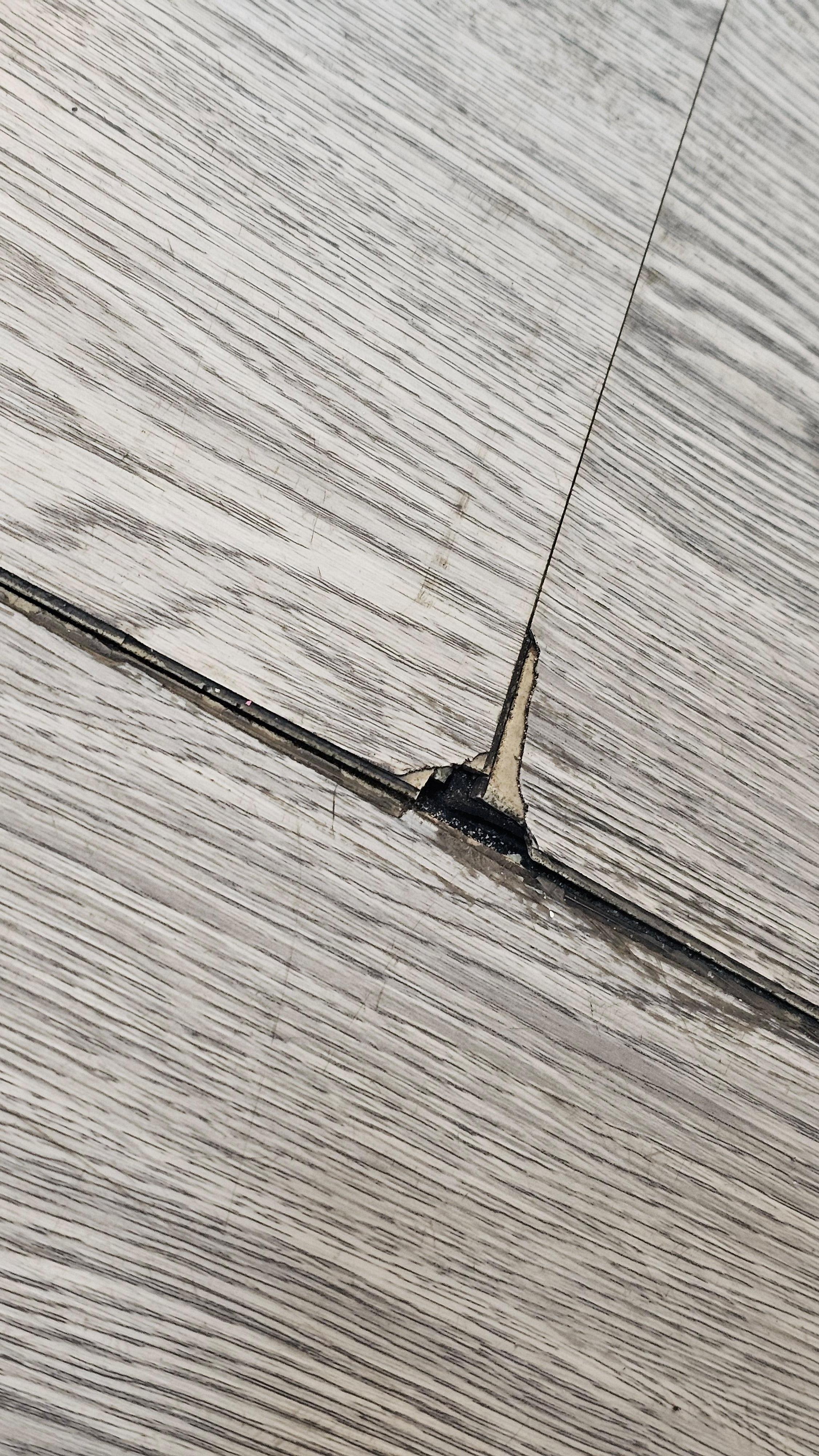 Room vinyl floor coming up all over the room.  Trip hazard & caused black dust all over floor.