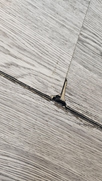 Room vinyl floor coming up all over the room.  Trip hazard & caused black dust all over floor.