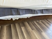 Bed base with torn fabric