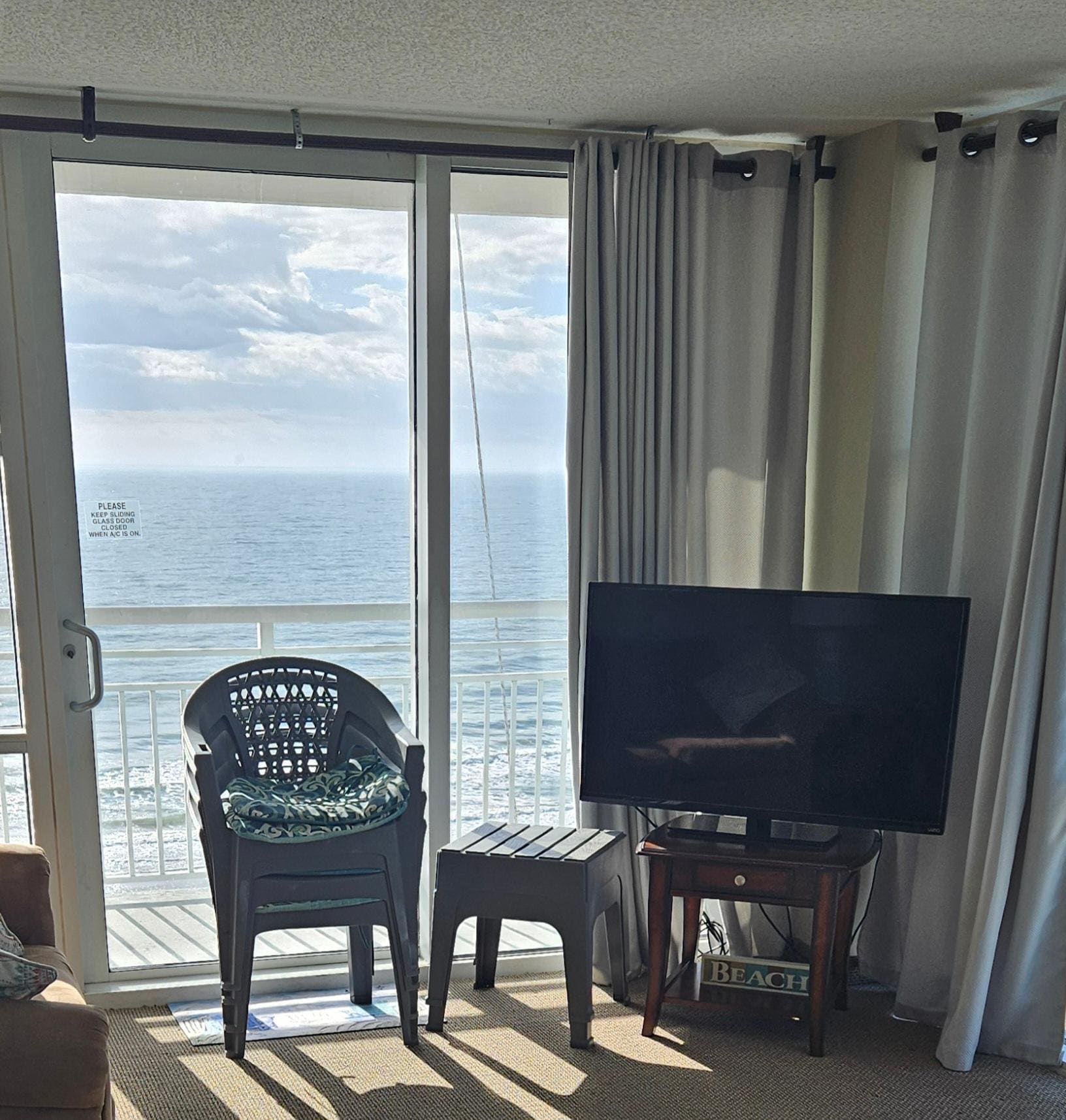 Balcony furniture inside, scaffolding ropes outside window
