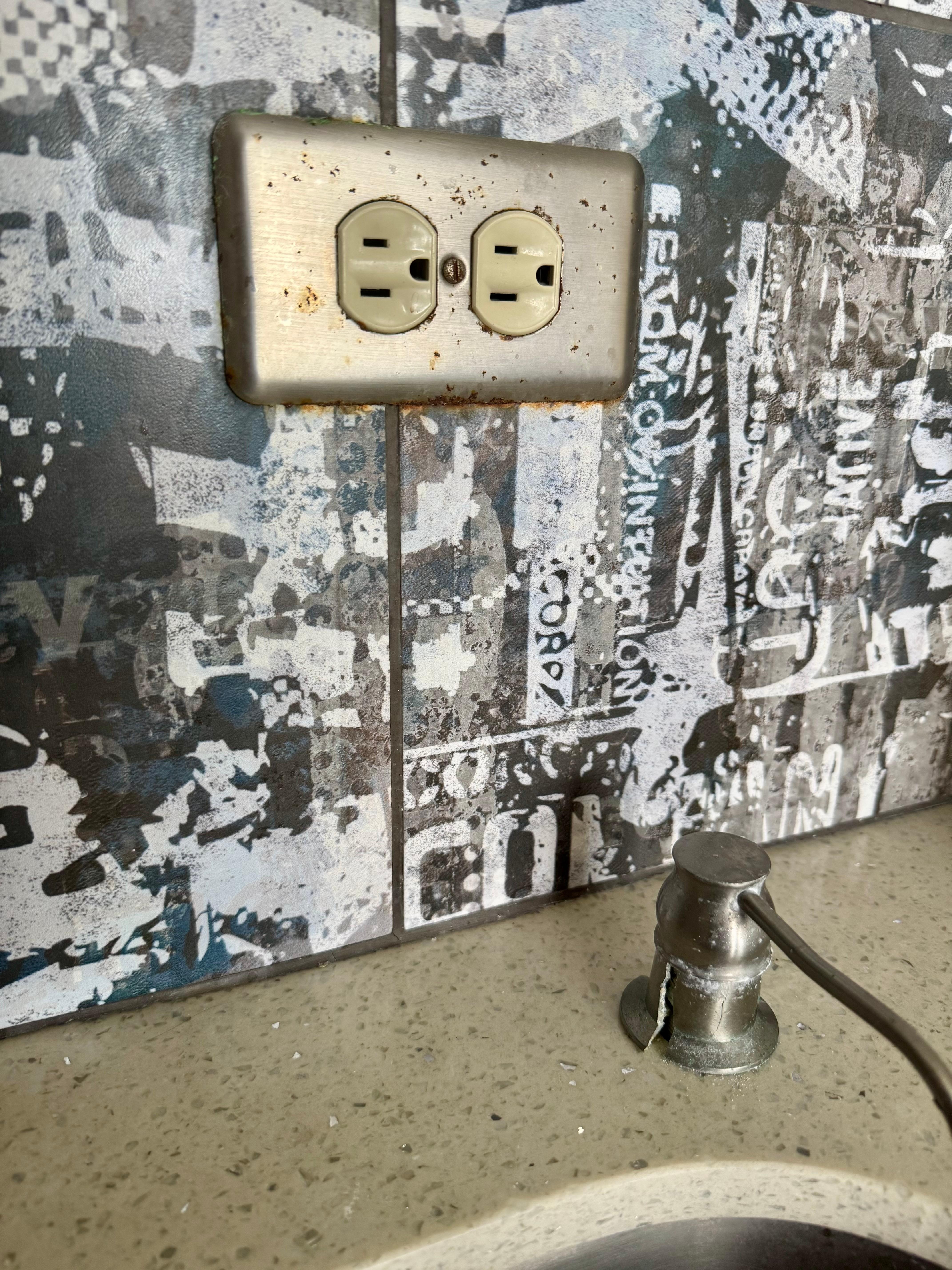 Old dirty kitchen with broken soap dispenser.