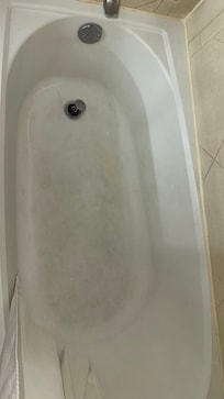 The shower curtains and the tub were stained.