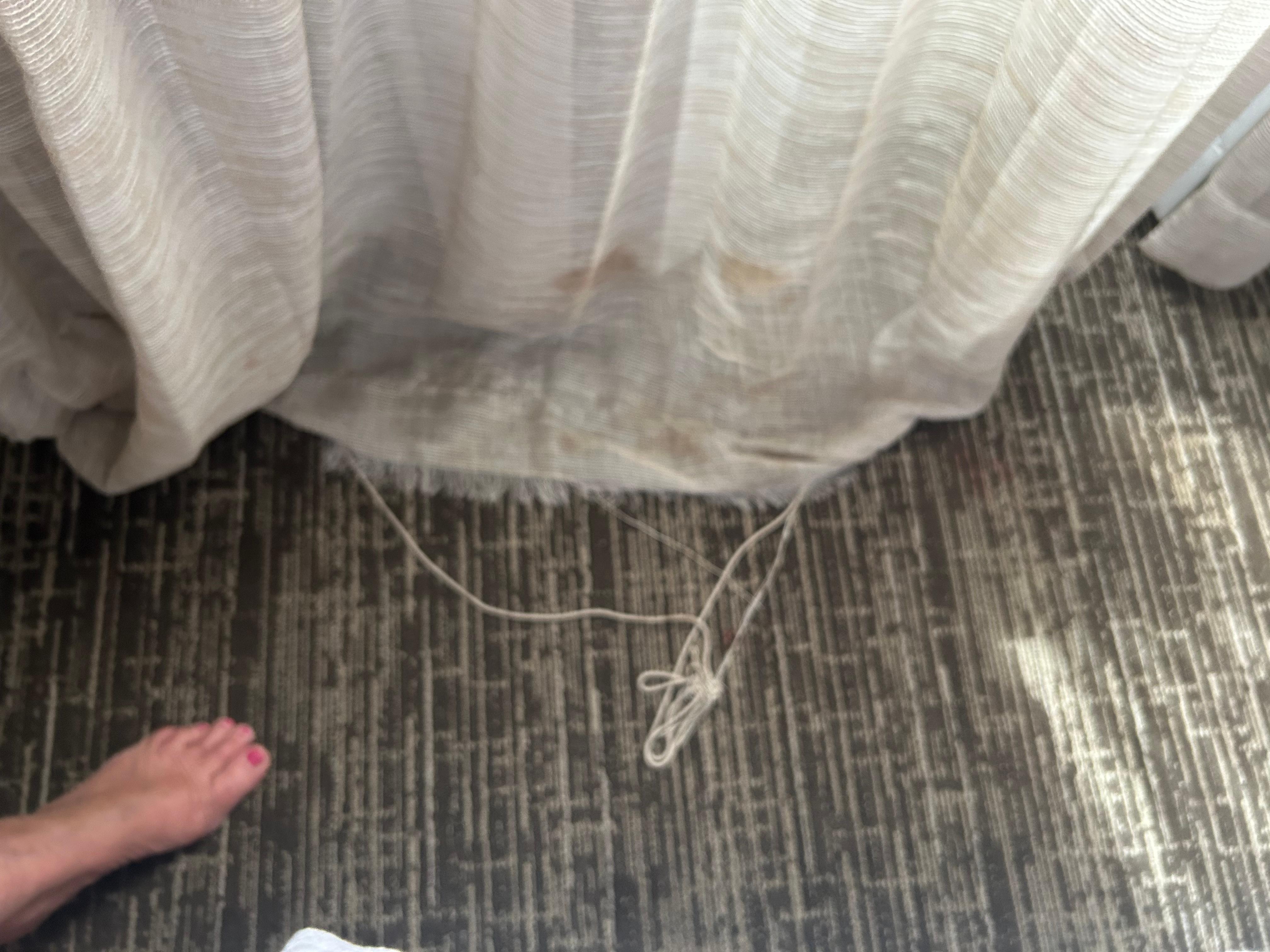 Frayed curtain at the bottom in the bedroom.