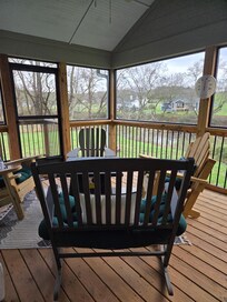 Beautiful screened porch with firepit right next to the river.