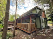 Inviting back porch with hot tub; perfect after long hikes in the Park.