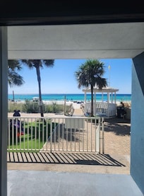 Our view from a sliding glass door that would not and does not lock from outside if you wanted to leave to beach that way. Who wants to leave their personal belongings for anyone to go in and steal! Cant trust anyone. Had to walk around.