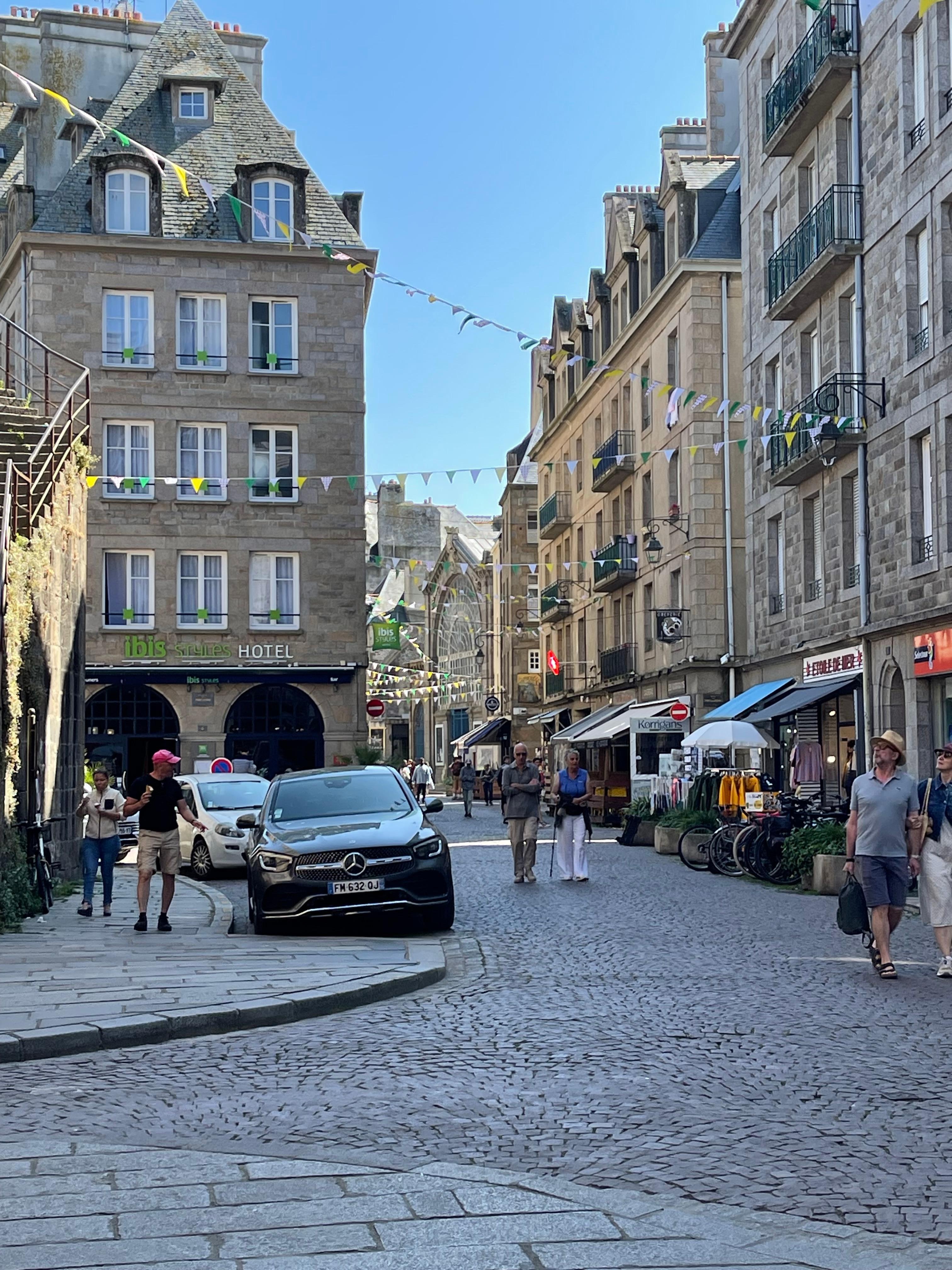 Traffic and cobbled streets in St Malo