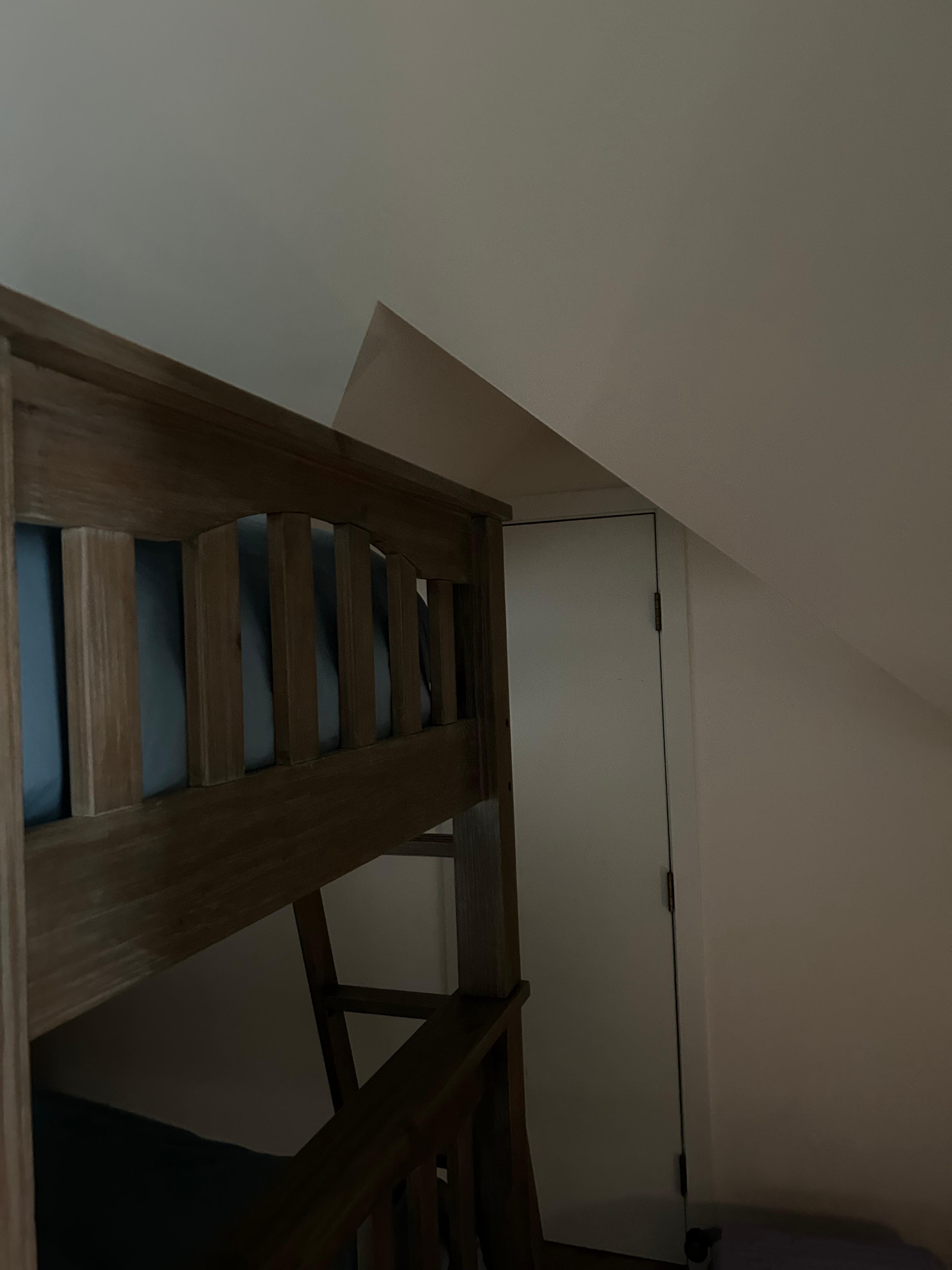 View of the location of the bunk ladder and the closet and arched ceiling.