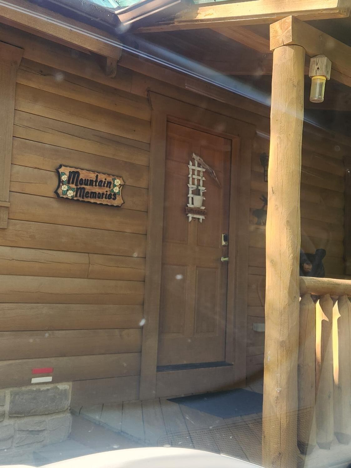 Front of Cabin (welcome bear peaking over rail)
