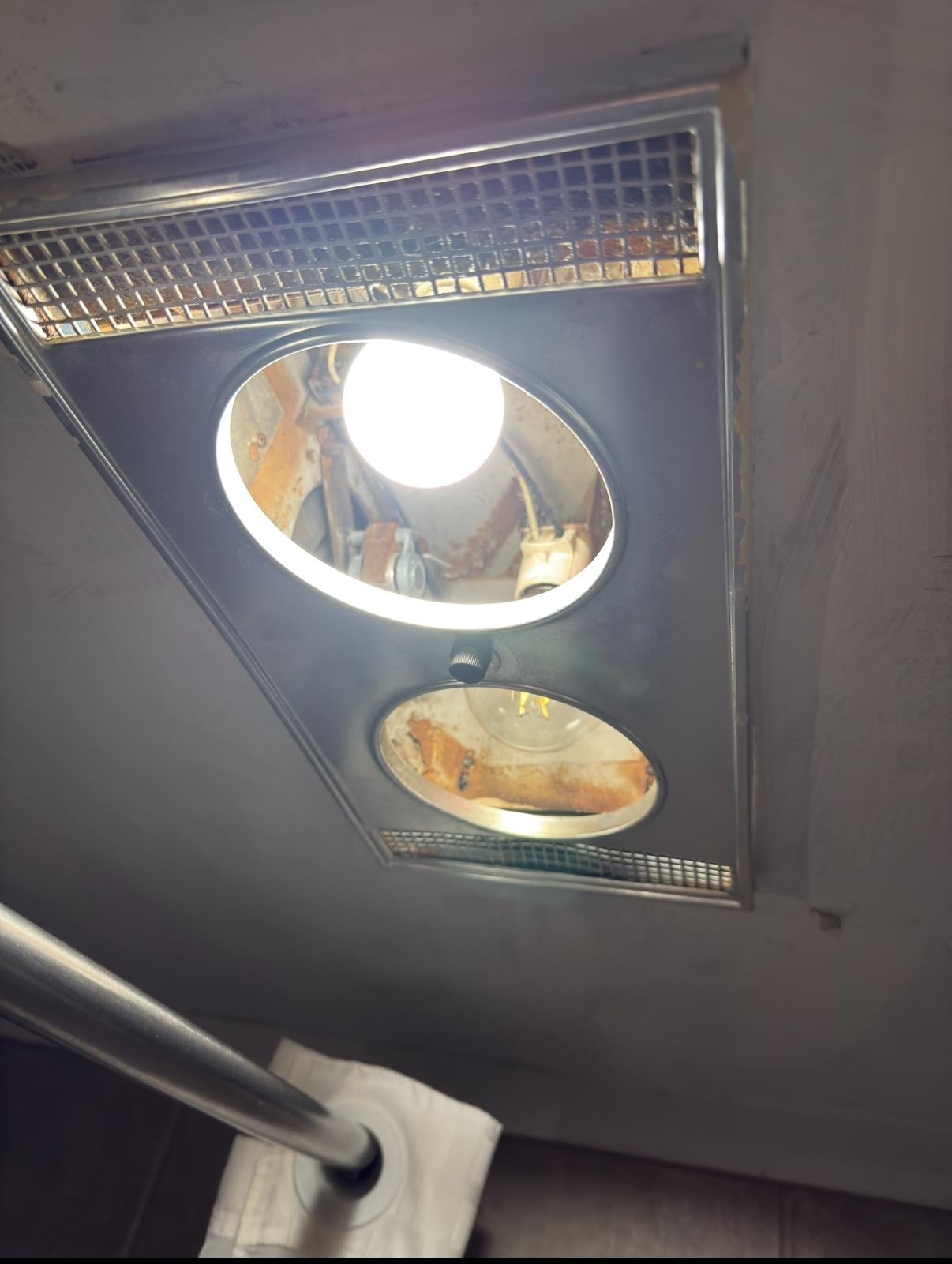 Exposed bulbs and wiring near shower