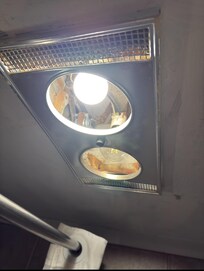 Exposed bulbs and wiring near shower