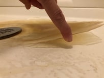 piece coming up off shower floor