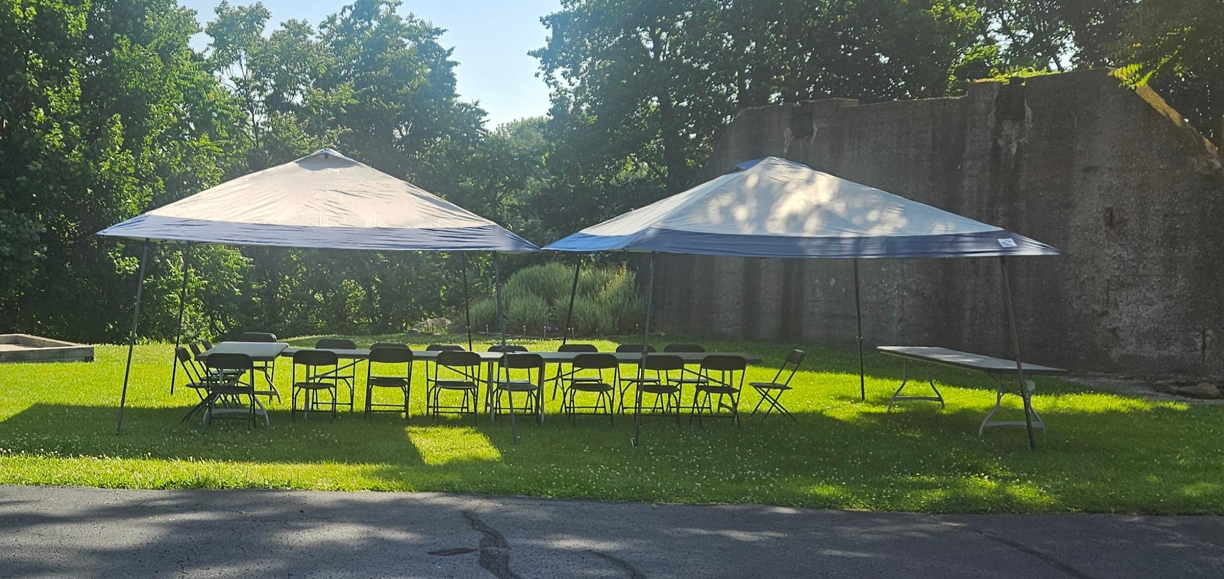 Set up for family picnic in large yard next to the bocce court.  