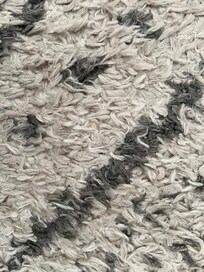 Area rug in master bedroom. Should have been cleaned or replaced.