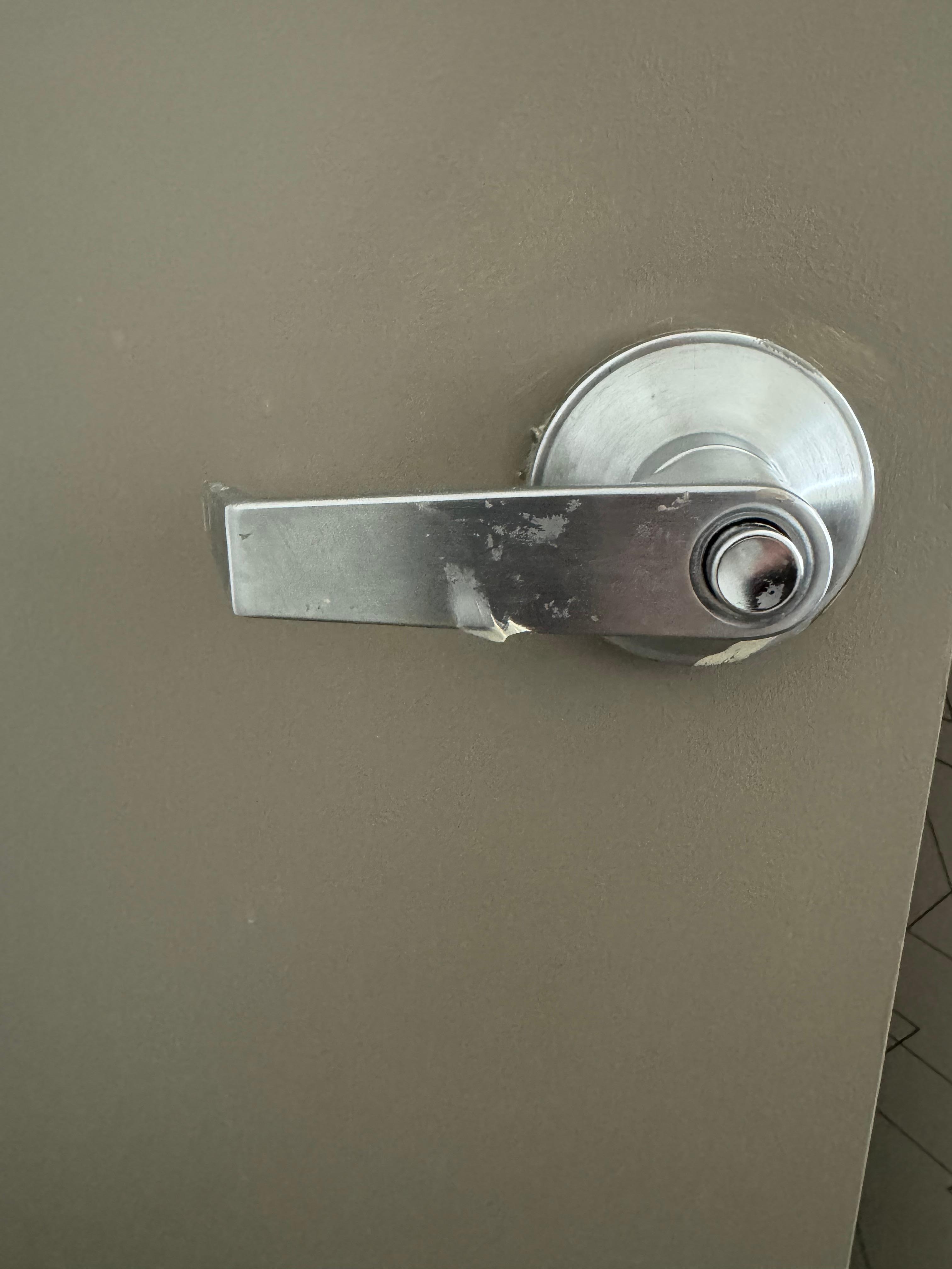 Caulk under & behind bathroom door handle