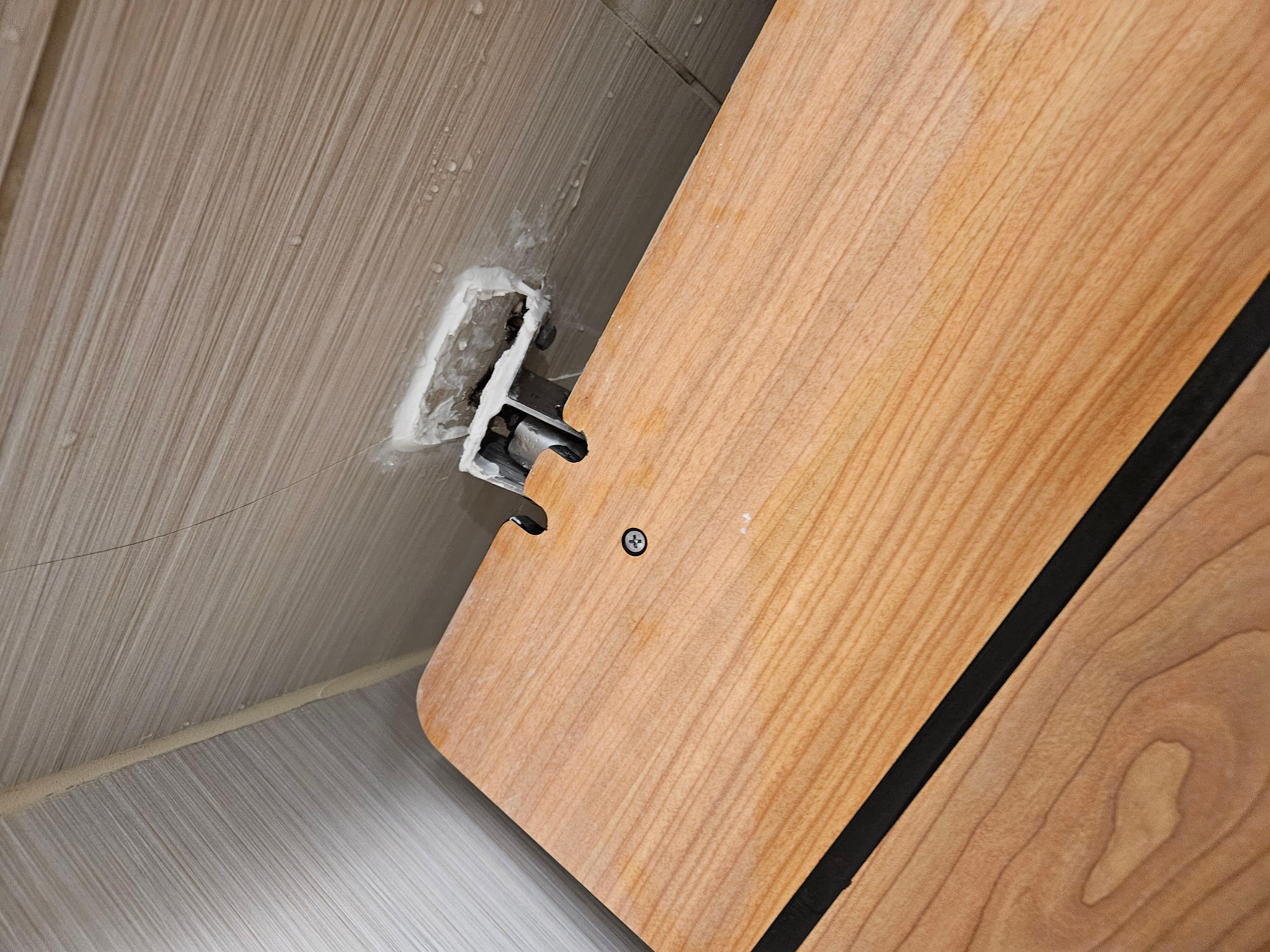 Shower chair hanging off the wall