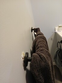 Towel bar pulled away from the wall
