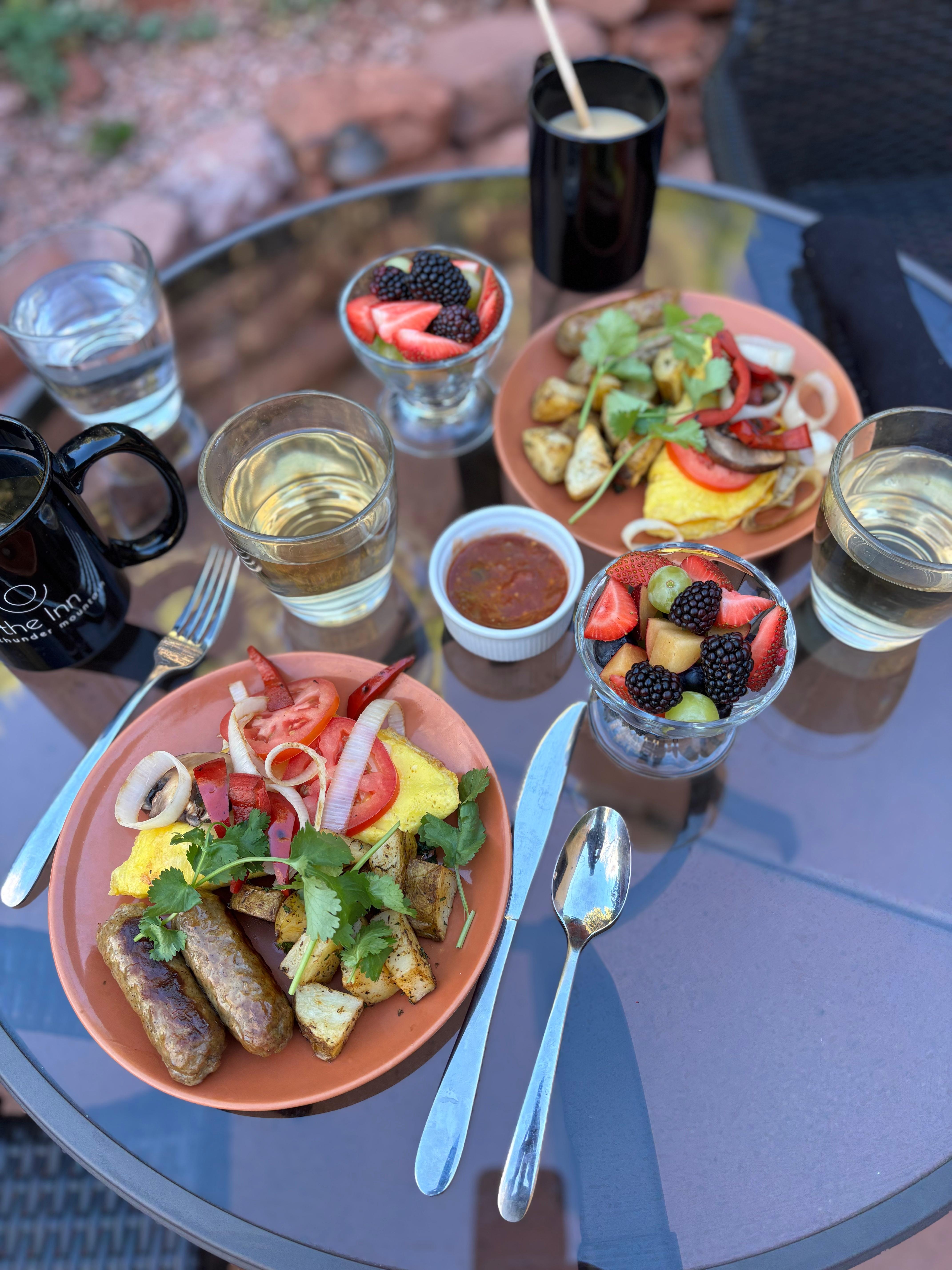 Omelette, sausage, roasted vegetables, salsa, juice and fruit