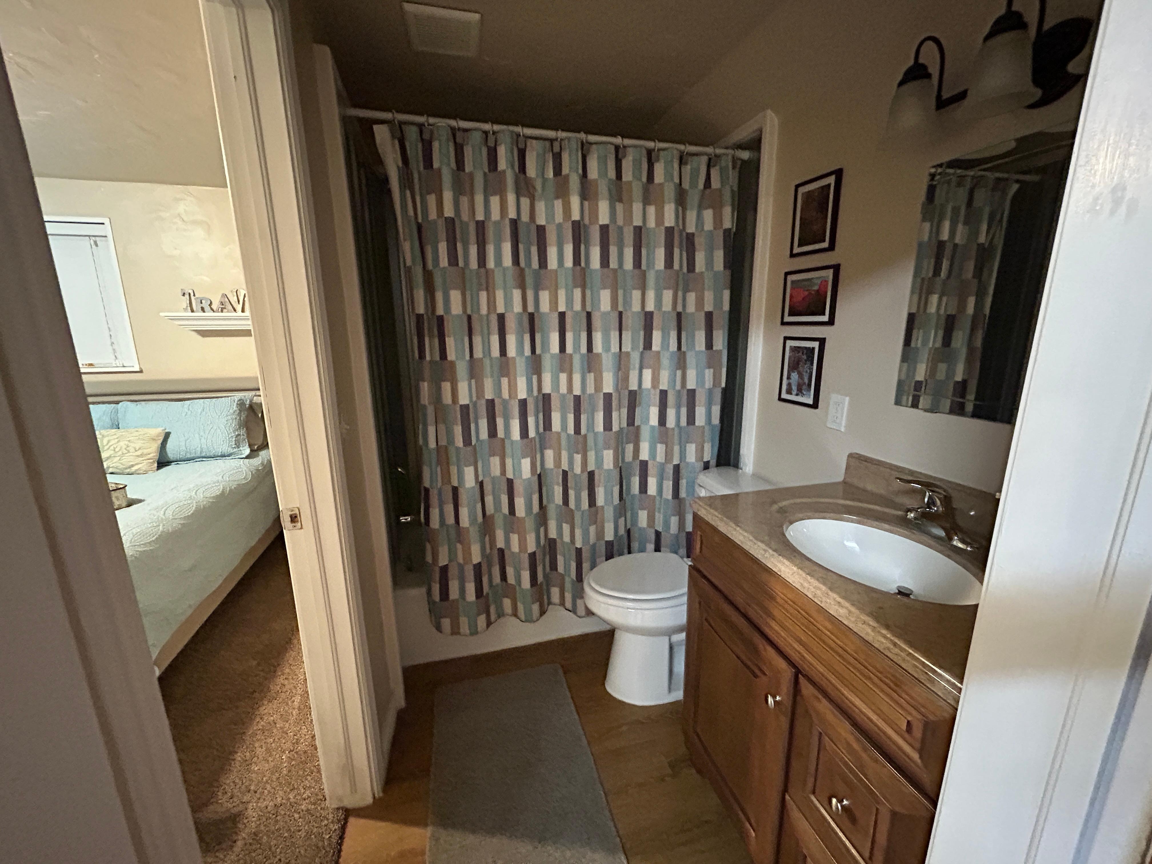 Bathroom as seen from the living area (two doors—one leading into bedroom, the other leading to dining area)
