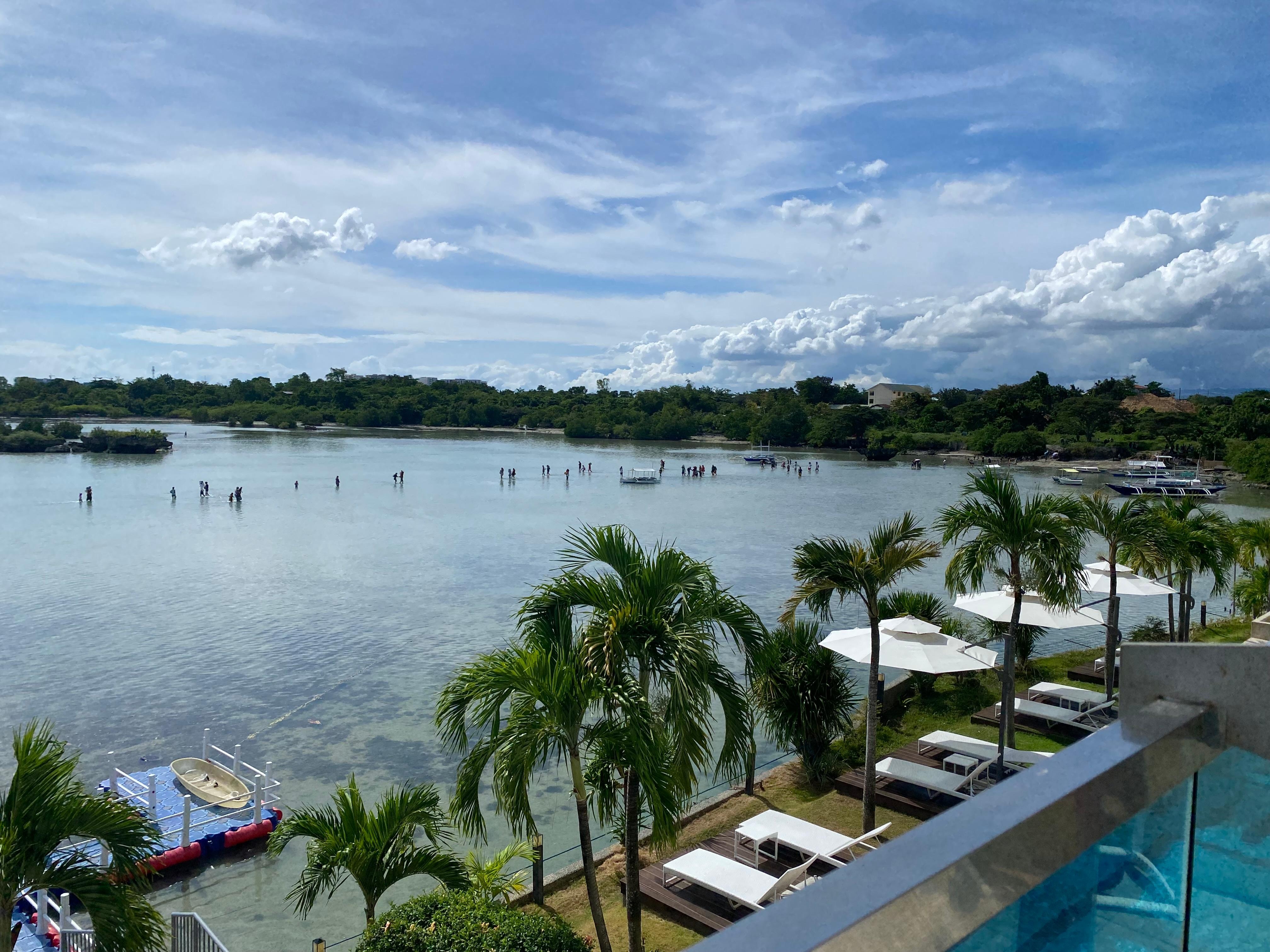 View from balcony. Locals walking to ocean to swim. 
