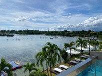 View from balcony. Locals walking to ocean to swim.