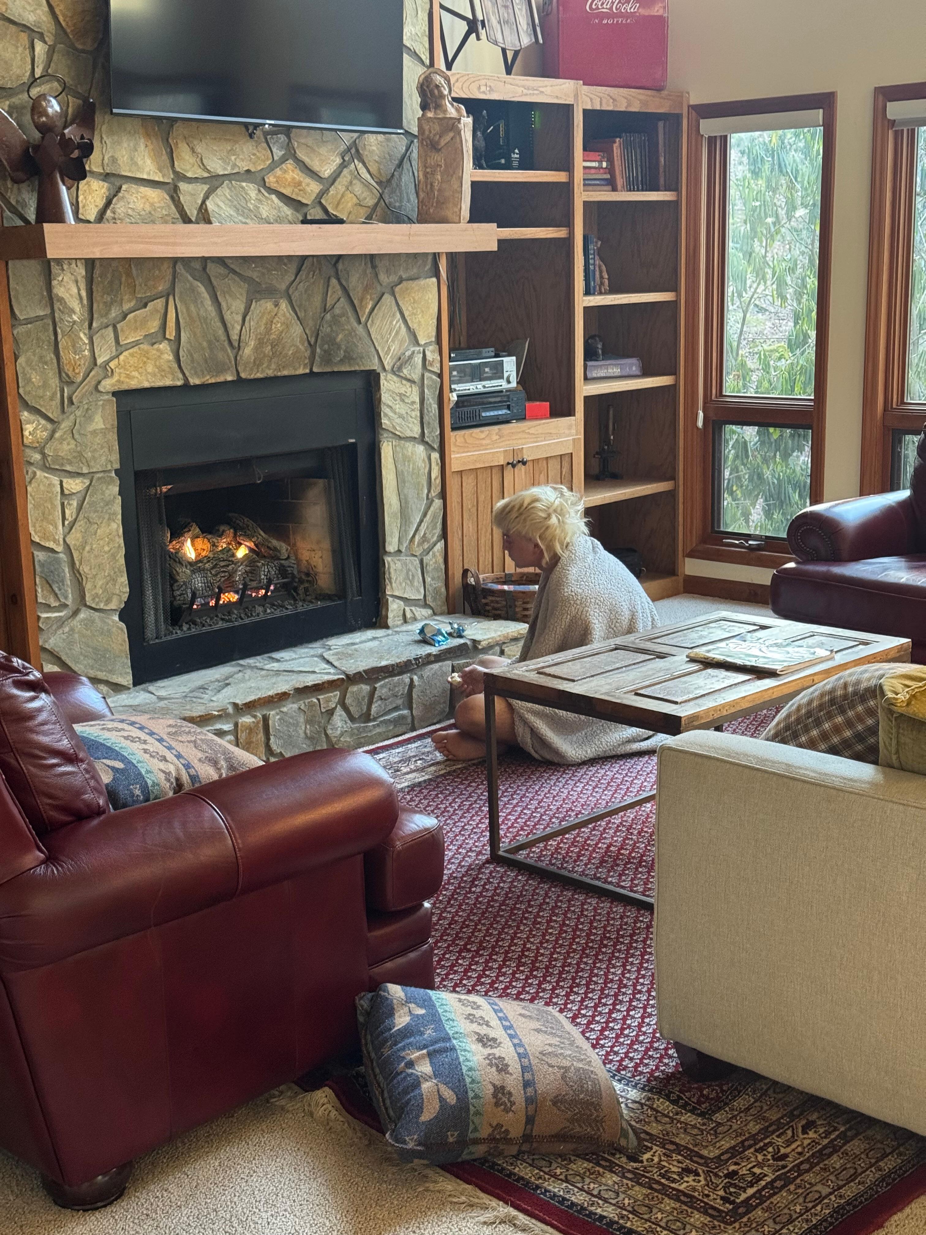 Cold teenager warming up by the fire!
