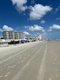 Beach outside hotel facilities, ocean immediately to right but not included in photo
