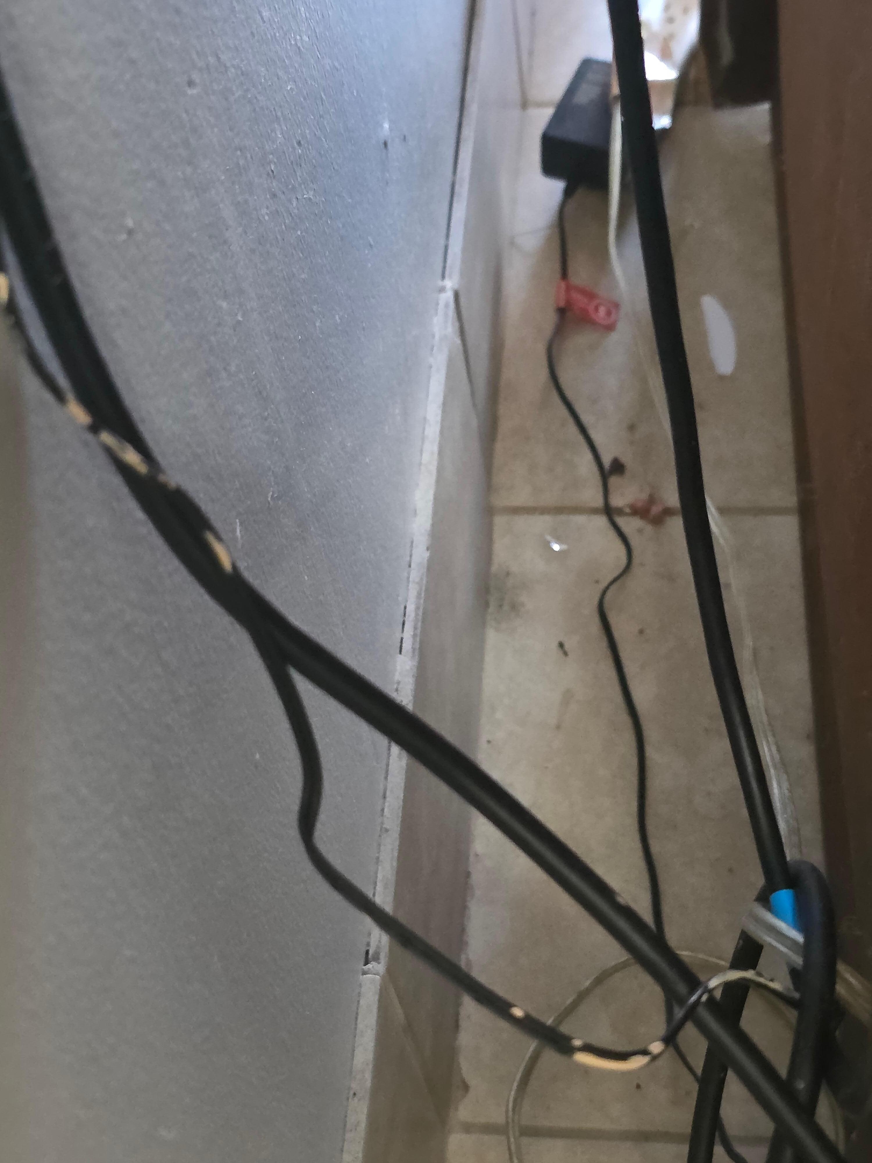 Behind tv stand