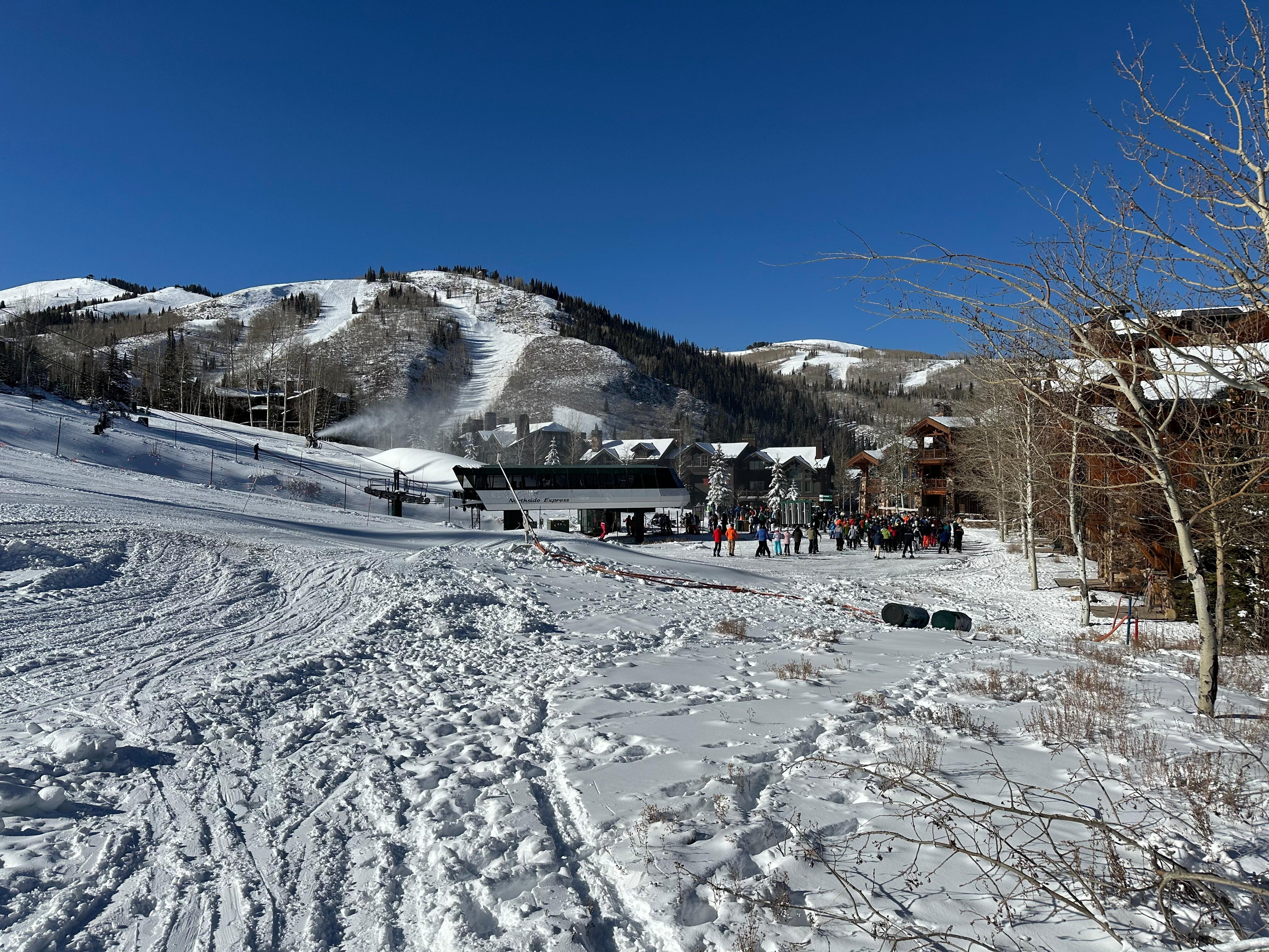 Ski trail and skiers lift line view from 30 ft outside house
