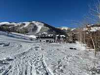 Ski trail and skiers lift line view from 30 ft outside house