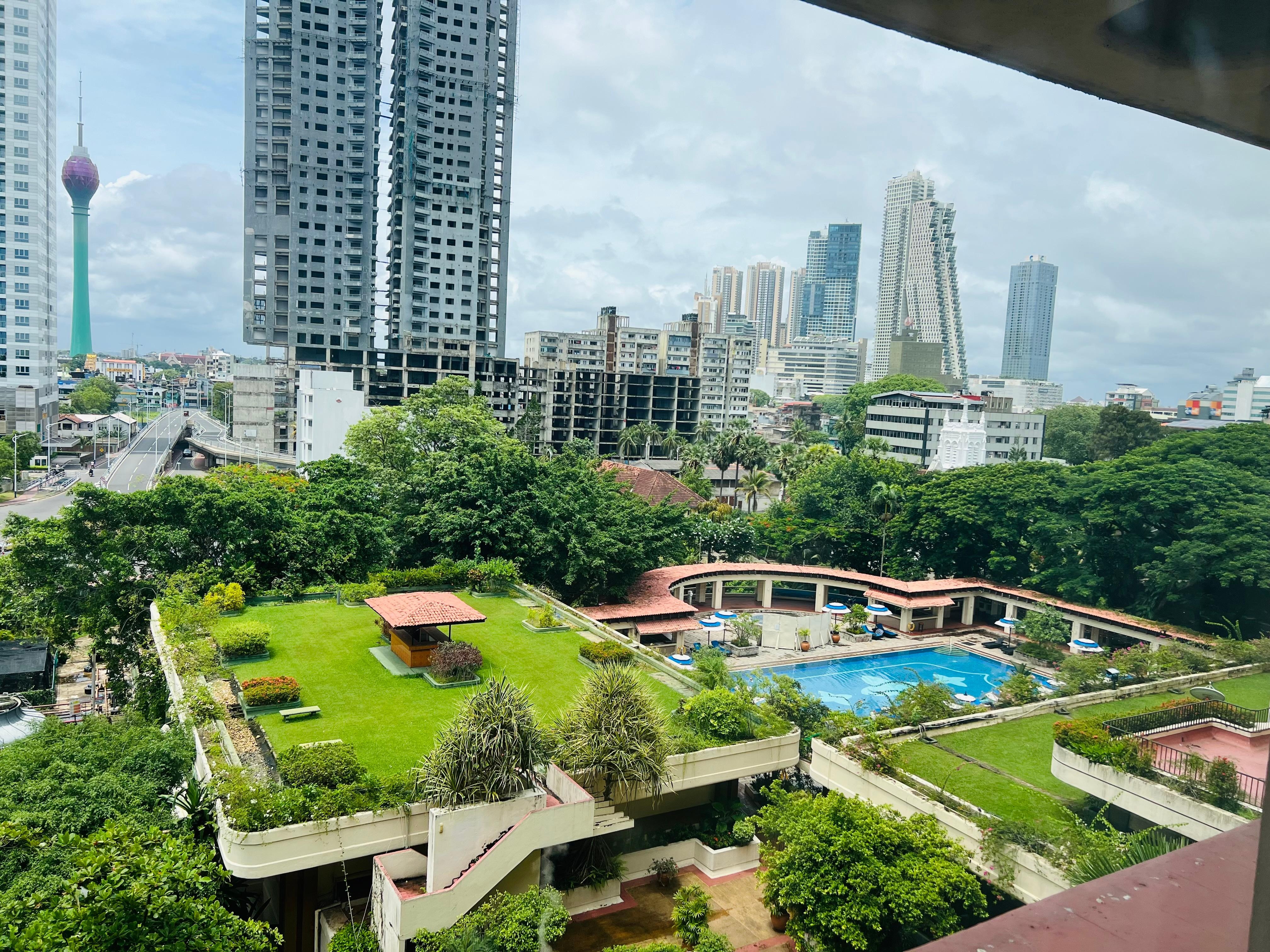 City view across eco-friendly Taj pool and gardens.