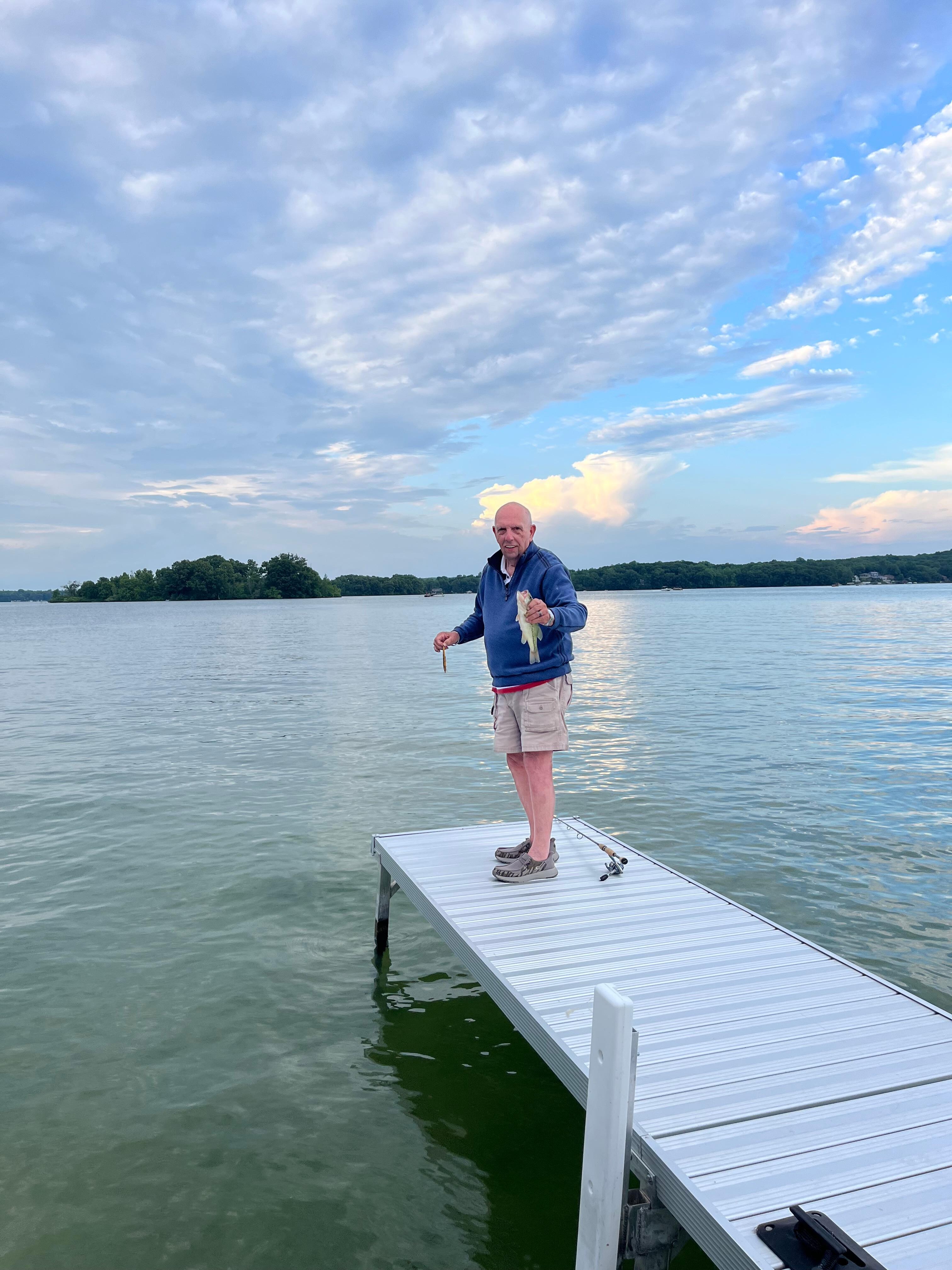 Husband catching bass off the pier.