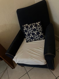 Severely stained chair with a sheet tucked into the bottom