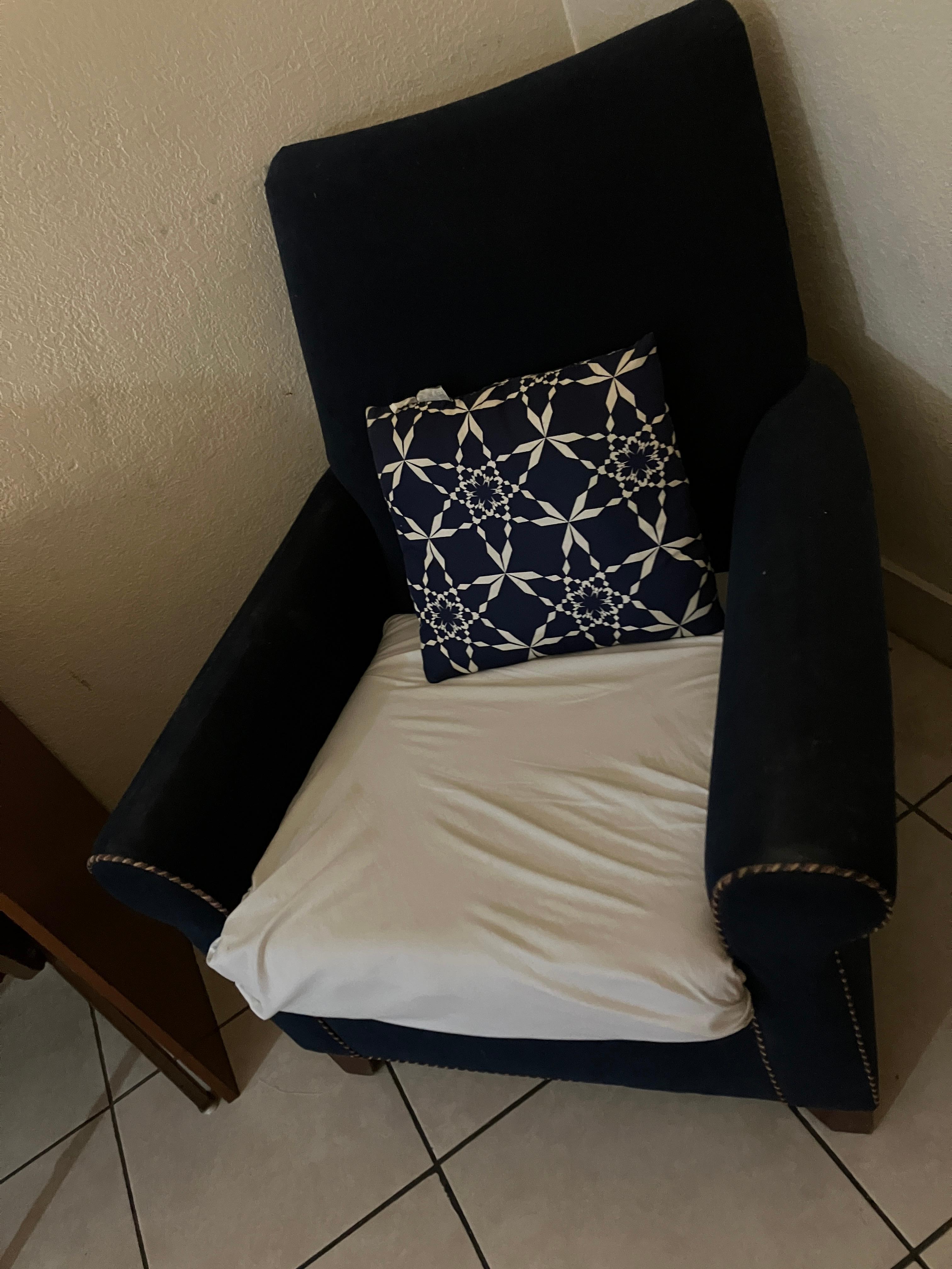 Severely stained chair with a sheet tucked into the bottom 