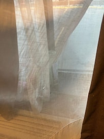There were holes and burns all through the curtains in the room.