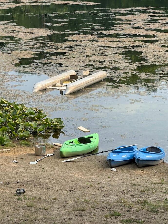 upside down pontoon in lake and dirty beach