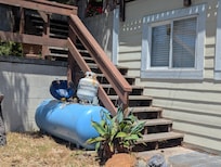 Empty propane tank with jury rigged BBQ tank to serve house. Fix done on second day of rental.