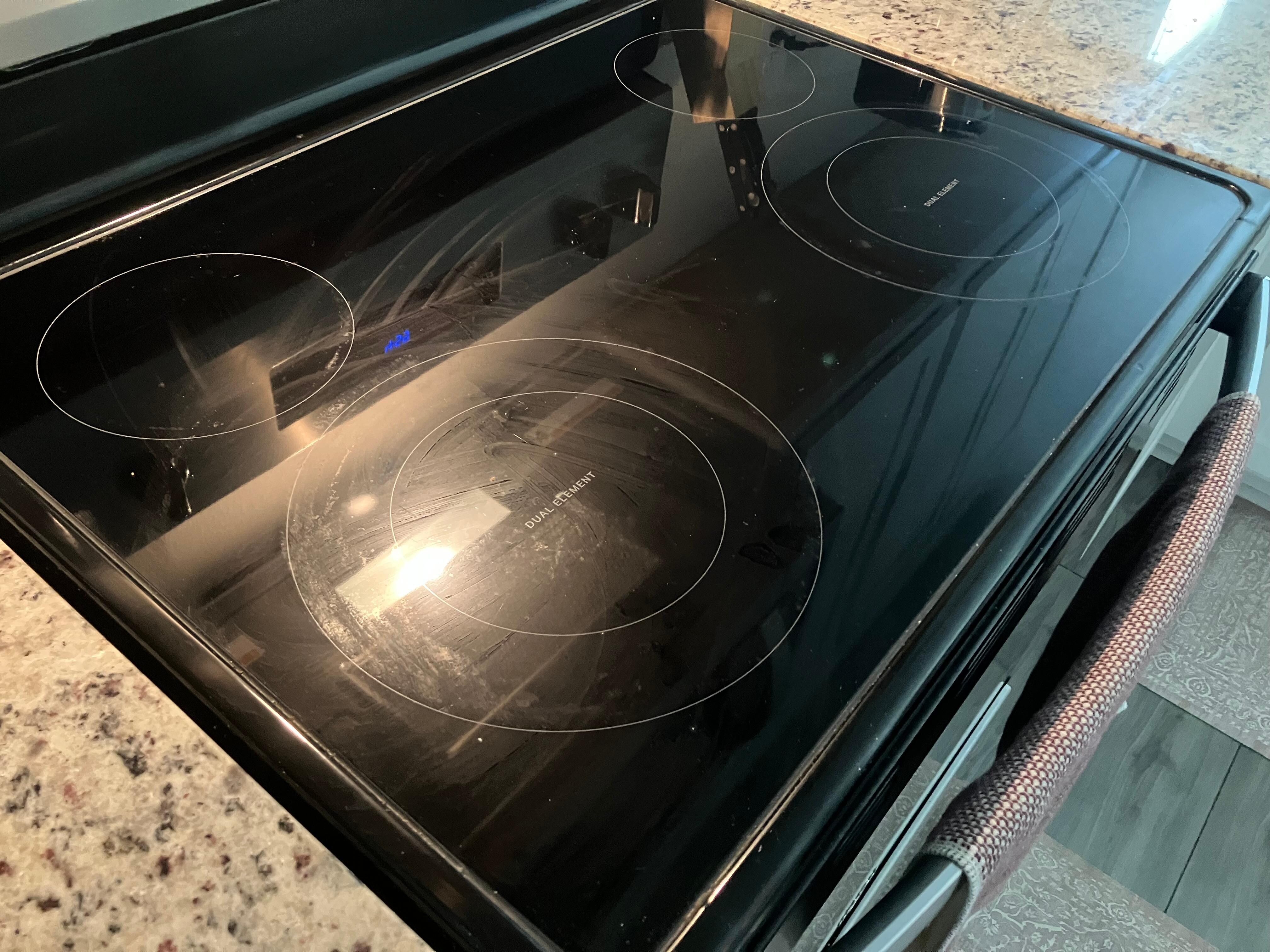 The stove top was wiped with a dirty cloth.