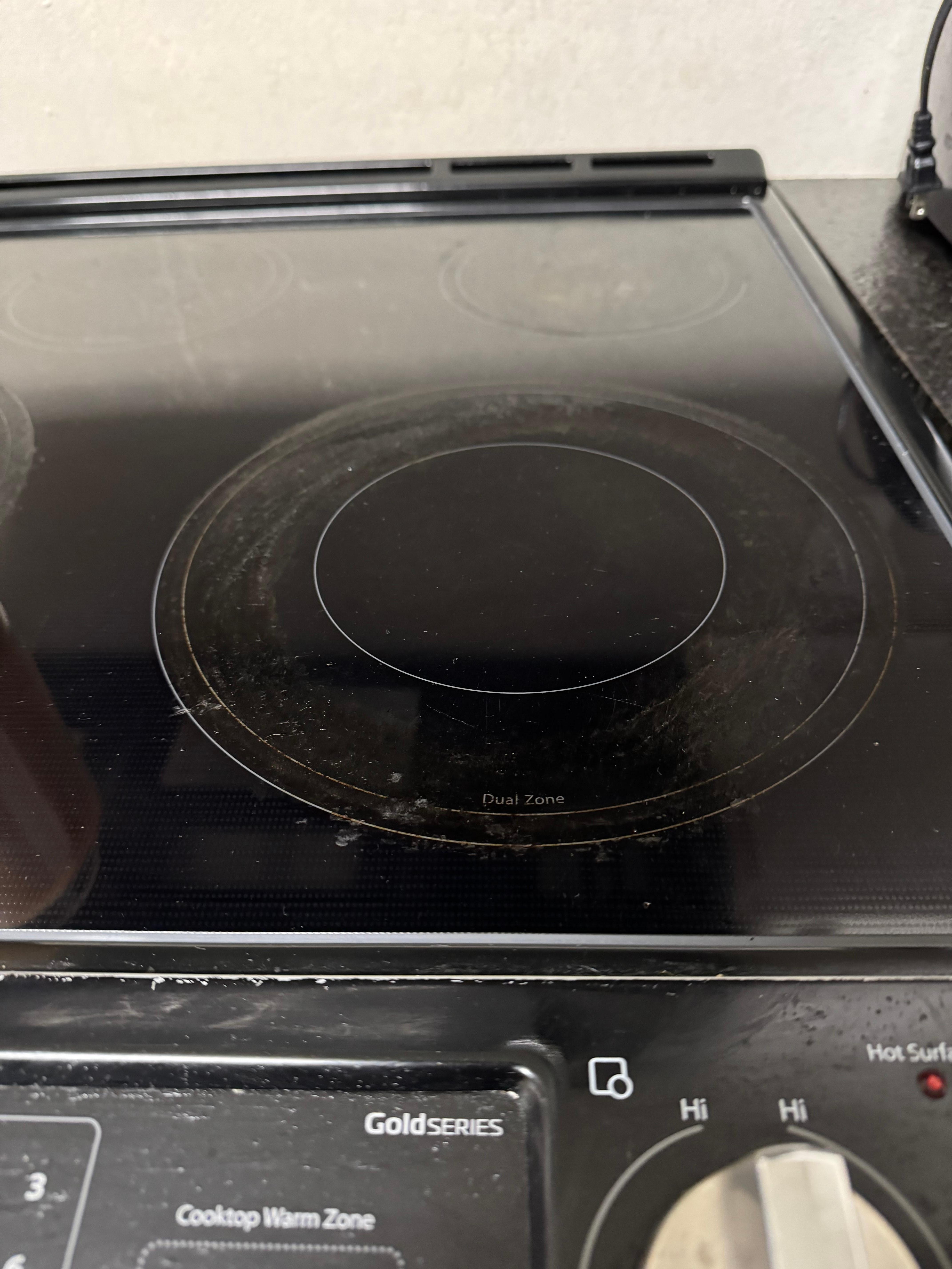 Grease caked on the cooktop on three burners