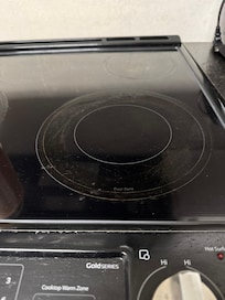 Grease caked on the cooktop on three burners