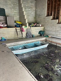 Boat house with gross algae and worn out equipment