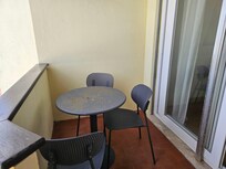 Balcony and rusted metal balcony table and chairs