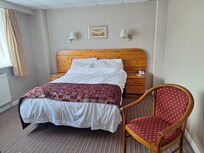 Pine themed bedroom. No air-conditioning, efficient fan provided.