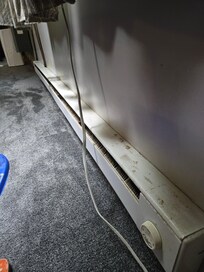 Baseboard heaters were dirty and covered in rust.