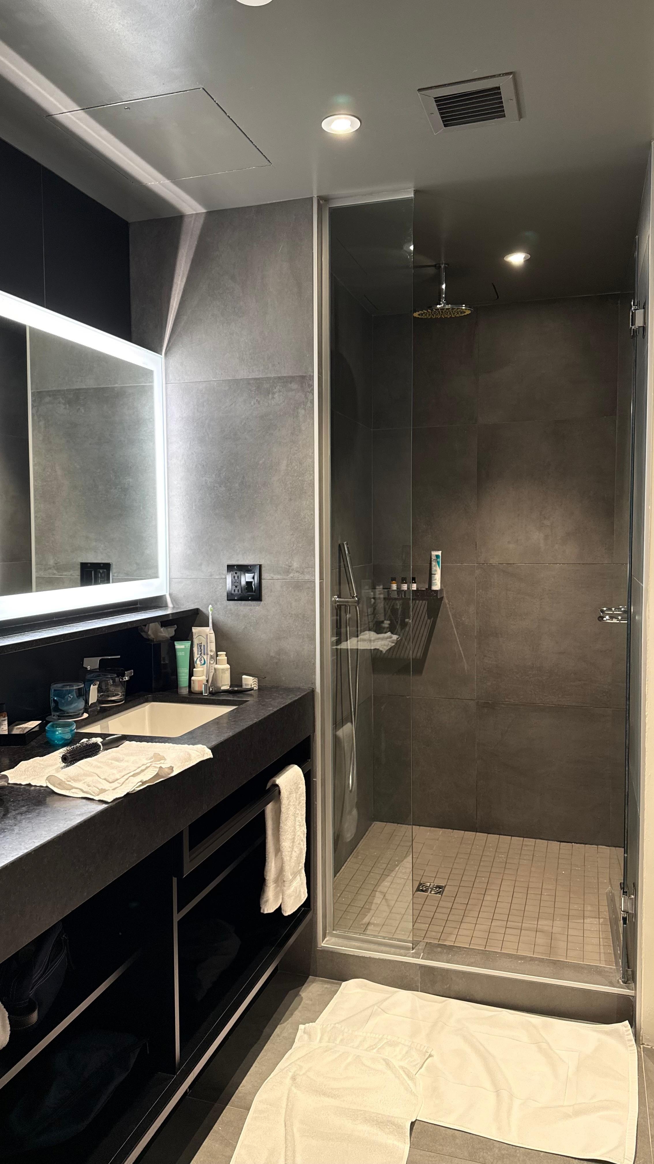 Tiled bathroom, well lit.